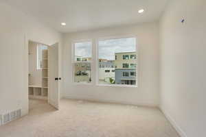 Carpeted spare room featuring recessed lighting