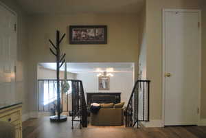 Sitting room with a fireplace and wood finished floors