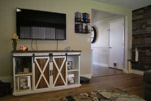 Bar with dark wood-style floors and a textured ceiling