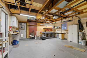 Garage featuring a workshop area and a garage door opener