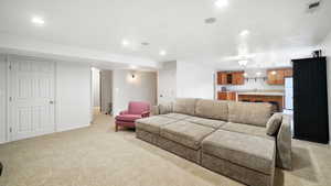 Living room featuring light colored carpet and recessed lighting