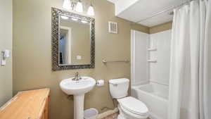 Bathroom with shower / bath combo and toilet