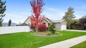 View of front of property with a mountain view, driveway, brick siding, and a garage