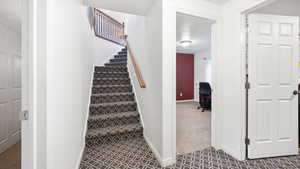 Stairs featuring carpet and baseboards