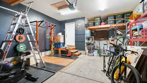 Garage with a workshop area and a garage door opener