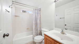 Full bathroom featuring shower / bath combo, vanity, and light tile patterned floors