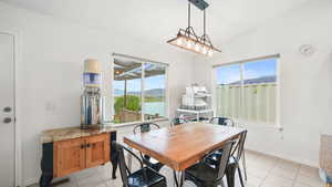 Dining area with healthy amount of natural light, light tile patterned floors, and a mountain view