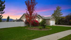 View of front facade featuring a garage, driveway, brick siding, and a mountain view