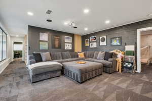 Carpeted living area with recessed lighting