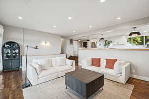 Living area featuring recessed lighting and dark wood-type flooring