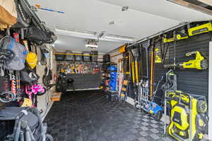 Garage featuring a workshop area and a garage door opener