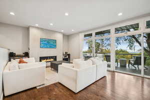 Living area with recessed lighting, a fireplace, and wood finished floors