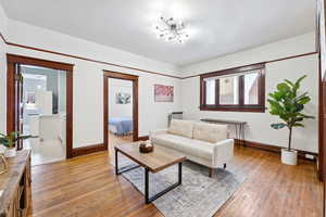 Living room with light wood-style flooring and baseboards