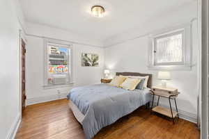 Bedroom featuring hardwood / wood-style flooring and cooling unit