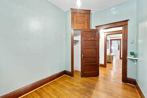 Unfurnished room featuring light wood-style flooring and baseboards