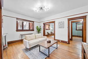 Living area featuring light wood finished floors and baseboard heating