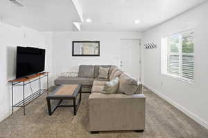 Living area featuring carpet flooring and recessed lighting