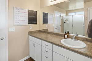 Bathroom featuring vanity and a shower stall