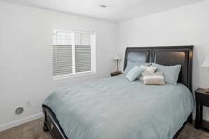 Carpeted bedroom featuring baseboards