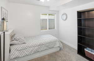 Bedroom with light colored carpet and ceiling fan