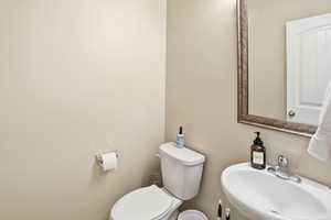 Half bathroom with a sink and toilet