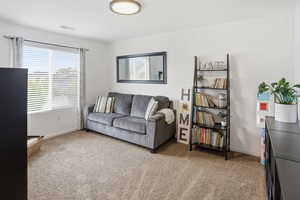 Living room with light colored carpet and baseboards