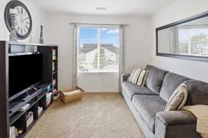 Living area with carpet floors and healthy amount of natural light
