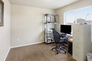 Carpeted home office with baseboards