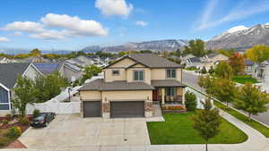 Traditional home featuring a residential view, a gate, a porch, concrete driveway, and a mountain view