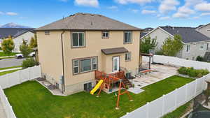 Back of house featuring a patio, a fenced backyard, stucco siding, and roof with shingles