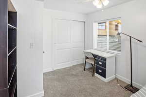 Office featuring light carpet and a ceiling fan