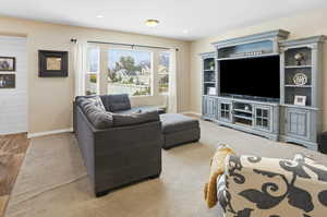 Carpeted living room featuring baseboards