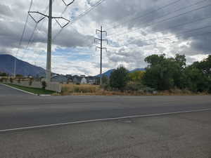 View of asphalt street featuring a mountain view