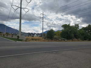 View of asphalt street featuring a mountain view