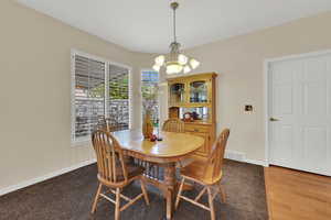 Dining area featuring a chandelier and wood finished floors