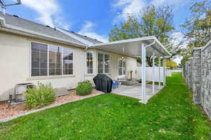 Back of property with a patio area, stucco siding, and a shingled roof