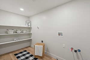 Washroom featuring light wood-style flooring, washer hookup, recessed lighting, and hookup for an electric dryer