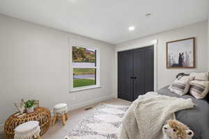 Bedroom with carpet flooring, a closet, and recessed lighting