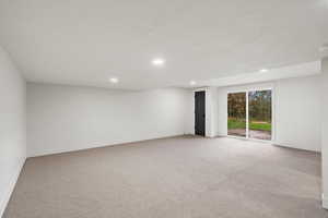 Spare room with light carpet and recessed lighting