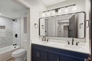 Bathroom with double vanity and shower / bath combination