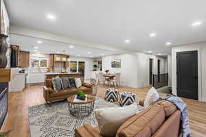 Living room with light wood-style floors and recessed lighting