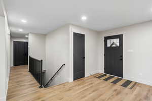 Entrance foyer with recessed lighting and light wood-style flooring