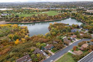 Aerial perspective of suburban area featuring a nearby body of water