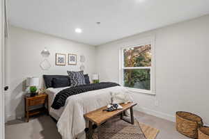 Carpeted bedroom with baseboards and recessed lighting