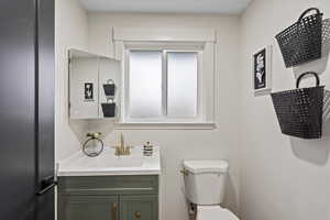 Half bath featuring vanity and toilet