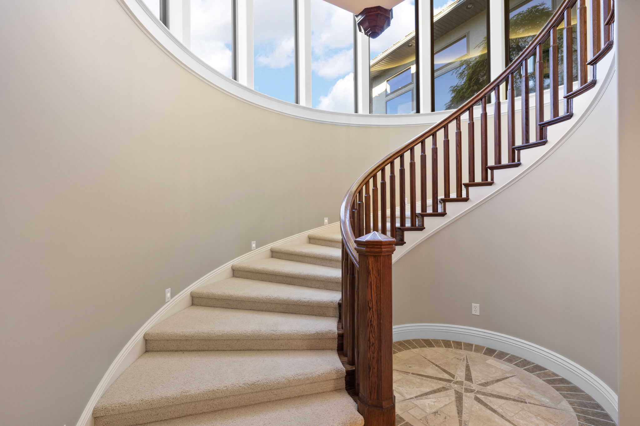 Large spiral staircase leads to lower level