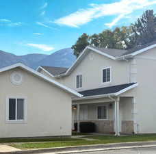 View of front of home with stucco siding and a mountain view