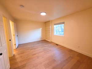 Unfurnished room featuring light wood finished floors and a smoke detector