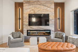 Living area featuring wood finished floors and a fireplace