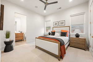 Bedroom with light carpet, ensuite bathroom, ceiling fan, and recessed lighting
